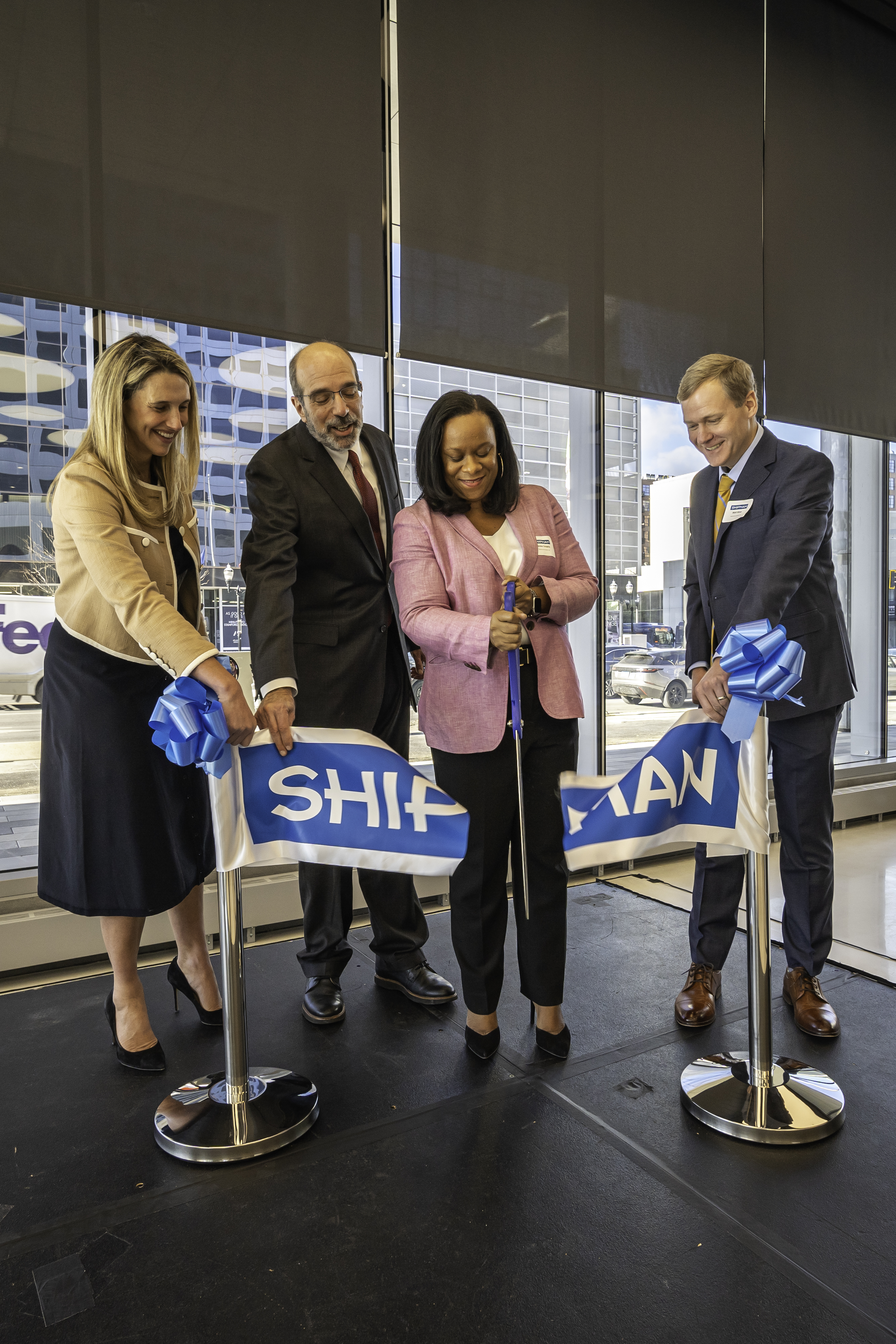 picture of Mayor of Stamford and firm dignitaries cutting ribbon at new Stamford location